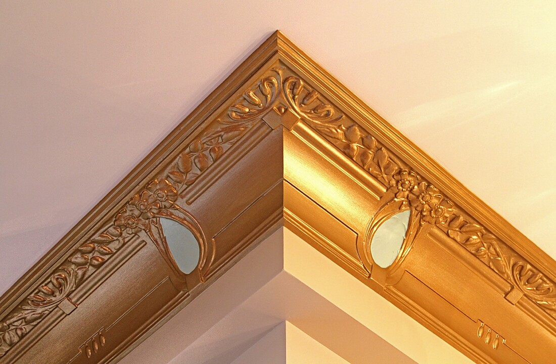 Detail of a gilded plaster ceiling corner moulding