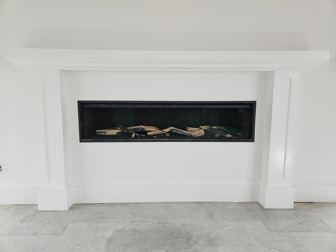 Custom fibrous plaster fireplace surround with linear gas fire in a new-build home