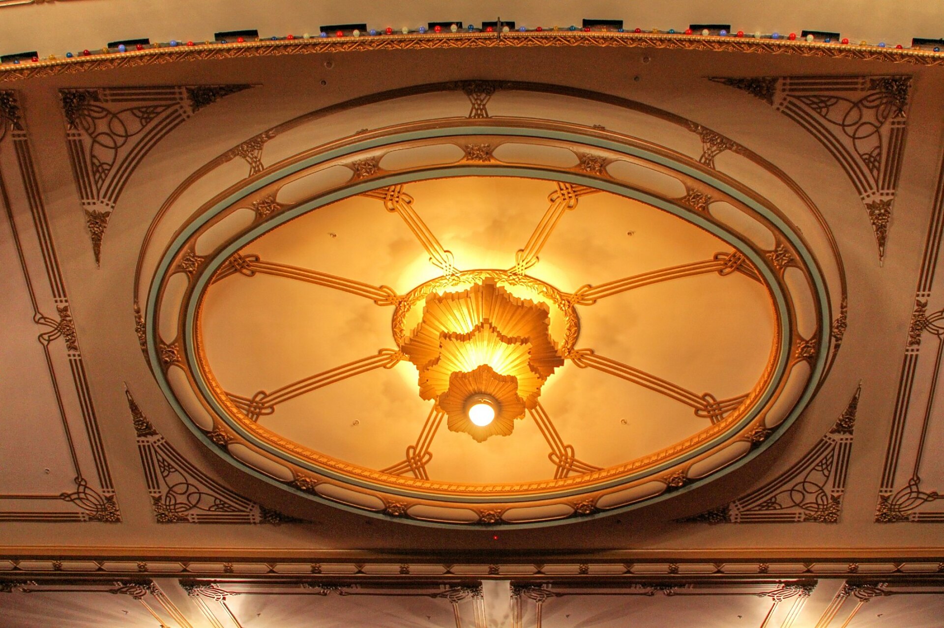 Ornate gilded ceiling medallion and light fitting at Toitoi, Hastings Opera House